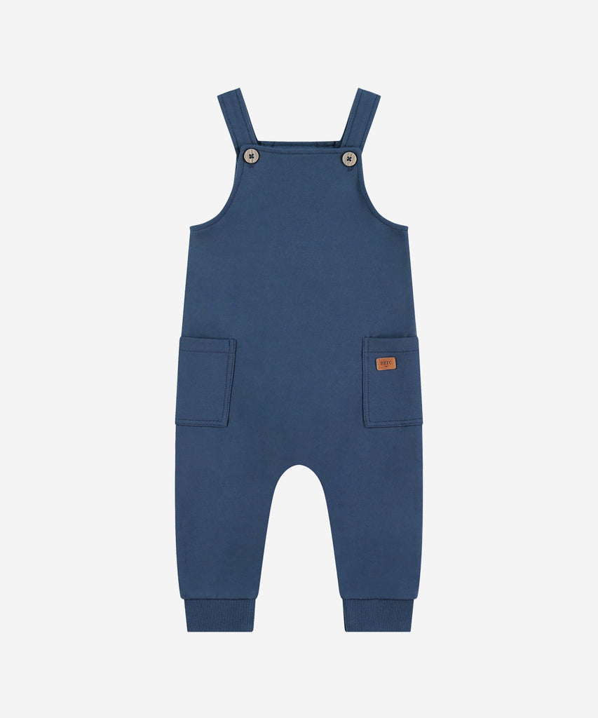 Details:&nbsp; Crafted from soft sweat material, these Baby Dungarees in Blue are the perfect addition to your little one's wardrobe. With a stylish dark blue hue and convenient pockets, these dungarees are both practical and comfortable. Perfect for all-day wear, your baby will look and feel great in these cozy dungarees.&nbsp;
Color:&nbsp;Dark blue&nbsp;&nbsp;
Composition: AW 24&nbsp;
