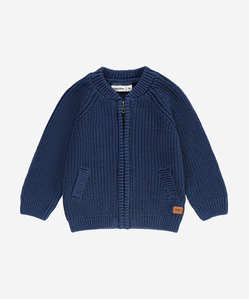 Details: &nbsp;This blue baby knit zip cardigan is designed with ribbed arm cuffs and waistband, as well as a round neckline, for a comfortable and stylish look. Keep your little one warm and cozy without sacrificing style. The perfect addition to any baby's wardrobe.&nbsp;
Color: Dark blue&nbsp;
Composition:&nbsp; Winter'24 &nbsp;
