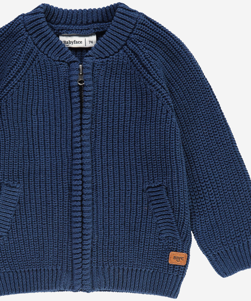 Details: &nbsp;This blue baby knit zip cardigan is designed with ribbed arm cuffs and waistband, as well as a round neckline, for a comfortable and stylish look. Keep your little one warm and cozy without sacrificing style. The perfect addition to any baby's wardrobe.&nbsp;
Color: Dark blue&nbsp;
Composition:&nbsp; Winter'24 &nbsp;