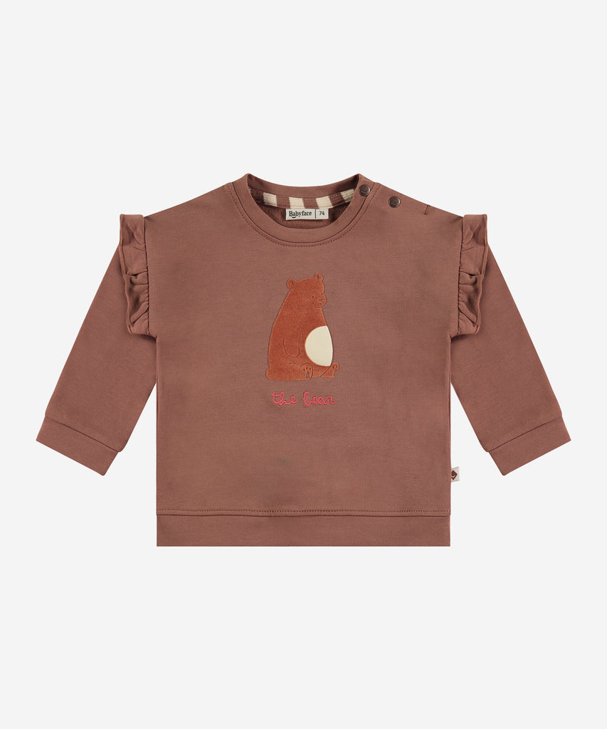 Details:&nbsp; This fashionable baby sweatshirt is made with a Bear print on the front and frills, a round neckline, ribbed arm cuffs and waistband, and push buttons on the side for easy opening. Perfect for any little one, this sweatshirt provides both comfort and style.&nbsp;
Color: Wood&nbsp;
Composition:&nbsp; 95% BCI cotton/5% elasthan &nbsp;