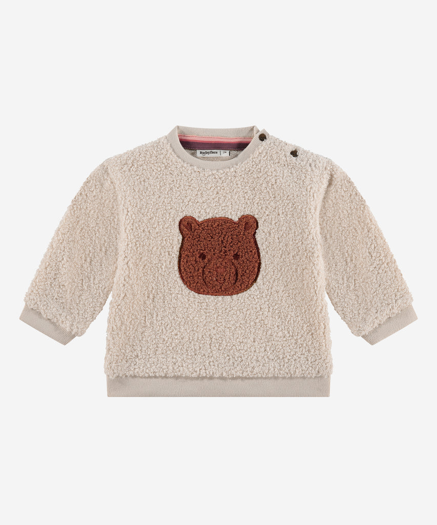 Details: &nbsp;This baby sweater is crafted from soft teddy fabric in a warm beige color, making it perfect for keeping your little one cozy. The adorable bear design on the front adds a playful touch, while the round neckline and ribbed arm cuffs and waistband provide a comfortable fit. A must-have for any stylish baby's wardrobe.&nbsp;
Color: Beige&nbsp;&nbsp;
Composition:&nbsp;100% polyester &nbsp;