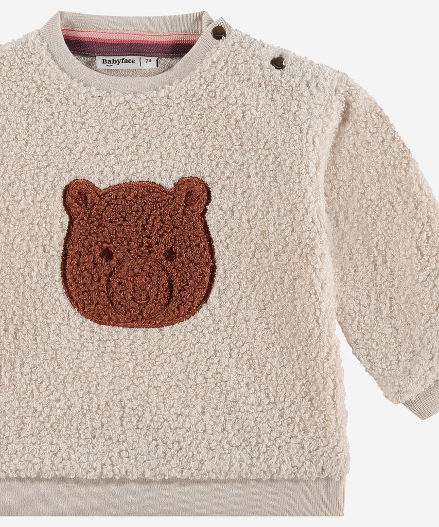 Details: &nbsp;This baby sweater is crafted from soft teddy fabric in a warm beige color, making it perfect for keeping your little one cozy. The adorable bear design on the front adds a playful touch, while the round neckline and ribbed arm cuffs and waistband provide a comfortable fit. A must-have for any stylish baby's wardrobe.&nbsp;
Color: Beige&nbsp;&nbsp;
Composition:&nbsp;100% polyester &nbsp;