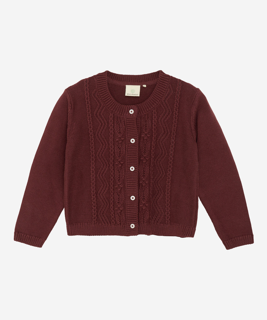 Details: &nbsp;This knitted cardigan in a rich plum color is the perfect addition to your wardrobe. The round neckline and button closure provide both style and comfort, making it a versatile piece for any occasion. Stay warm and stylish with this cozy cardigan. Color: Plum&nbsp; Composition:&nbsp;Organic Knit 100% Cotton&nbsp;