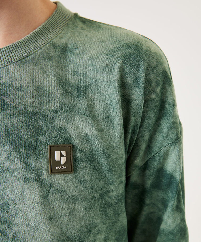 Details:&nbsp;This LS T-Shirt in Tie Dye Rucola Green features a comfortable round neckline and long sleeves. With its unique tie dye pattern and vibrant color, this shirt is sure to make a statement. Stay stylish and comfortable in this must-have piece.&nbsp;
Color: Rucola green&nbsp;&nbsp;
Composition:&nbsp; 100% Cotton&nbsp;