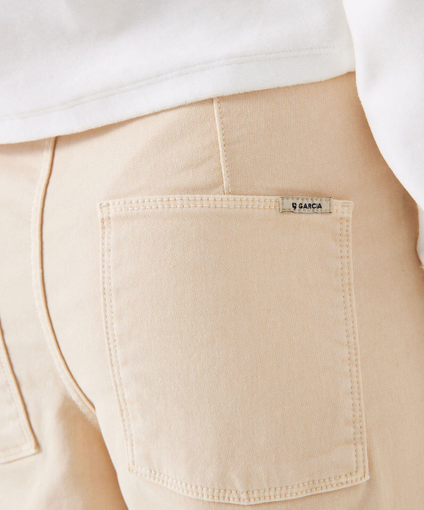 Details:&nbsp;Expertly designed with a wide leg for comfort and movement, these ivory cream cargo pants are essential for any wardrobe. The button zip closure and belt loops provide a secure fit, while the adjustable elastic on the inside ensures a tailored fit. Multiple pockets add functionality and convenience. Color: Ivory cream&nbsp; Composition:&nbsp; 98% Cotton, 2% Elasthan