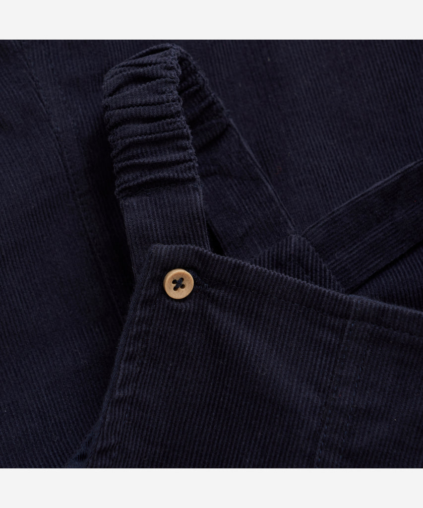 Details:&nbsp; Introducing our Baby Corduroy Overall in Night Blue - a stylish and durable choice for your little one. Made from soft corduroy, with a handy pocket and easy button closure, this overall provides both comfort and convenience. Perfect for any occasion and easy to clean.&nbsp; Color: Night blue&nbsp; Composition:&nbsp; Organic woven Corduroy 100% Cotton &nbsp;