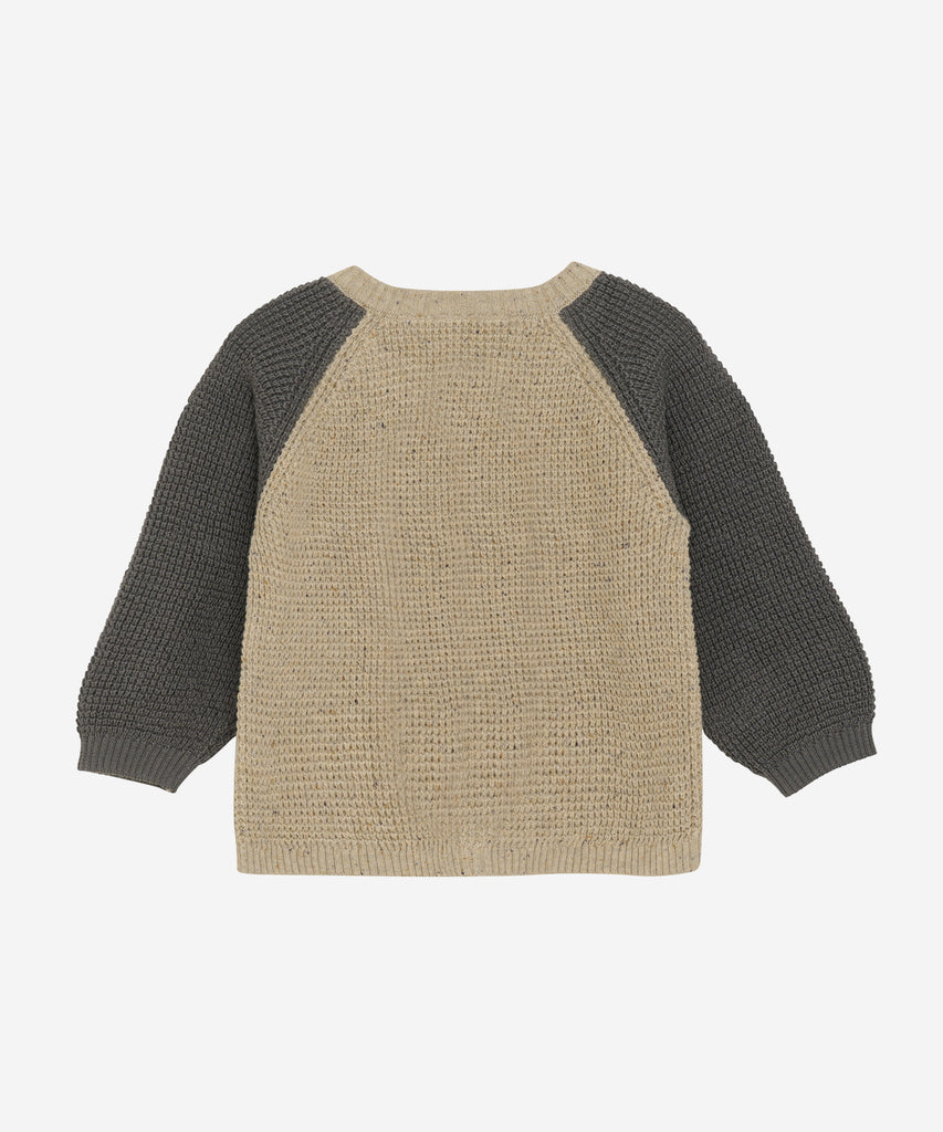 Details:&nbsp;This expertly-crafted Baby Knit Cardigan is made with a soft knitted fabric, perfect for your little one's delicate skin. The button closure adds convenience and security, while the classic design allows for easy pairing with any outfit. Keep your baby cozy and stylish with this essential piece. Round Neckline.&nbsp; Color: Beige melee grey&nbsp; Composition:&nbsp; Organic Knit 100% Cotton &nbsp;