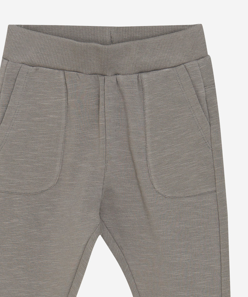 Details:&nbsp;These baby jogg pants are designed with comfort and style in mind. Soft and lightweight, each pair is equipped with an elastic waistband. Perfect for everyday wear.&nbsp; Color: Concrete&nbsp; Composition:&nbsp; Organic Sweat-slub Yarn 95% Cotton/ 5% Elastane &nbsp;