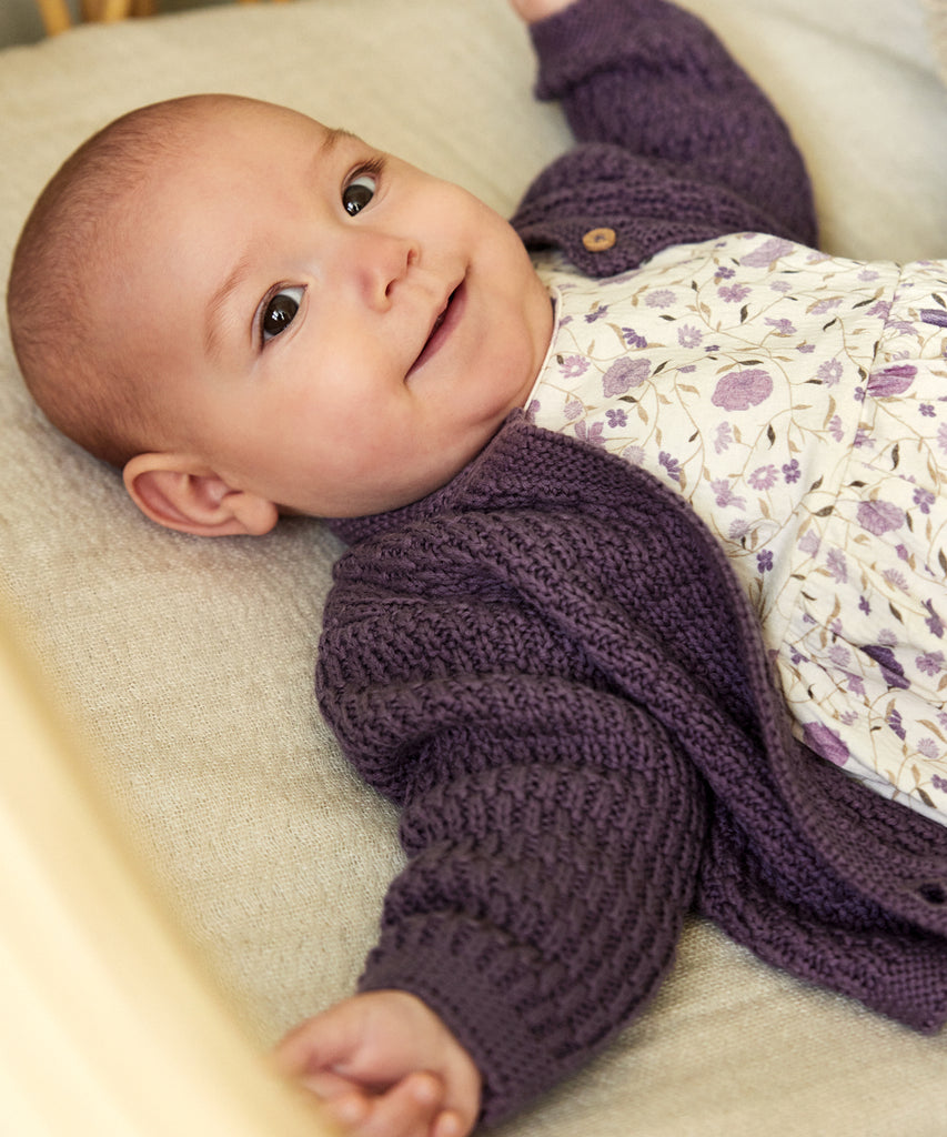 Details:&nbsp;This expertly-crafted Baby Knit Cardigan is made with a soft knitted fabric, perfect for your little one's delicate skin. The button closure adds convenience and security, while the classic design allows for easy pairing with any outfit. Keep your baby cozy and stylish with this essential piece. Round Neckline.&nbsp; Color: Black plum&nbsp; Composition:&nbsp; Organic Knit 100% Cotton &nbsp;