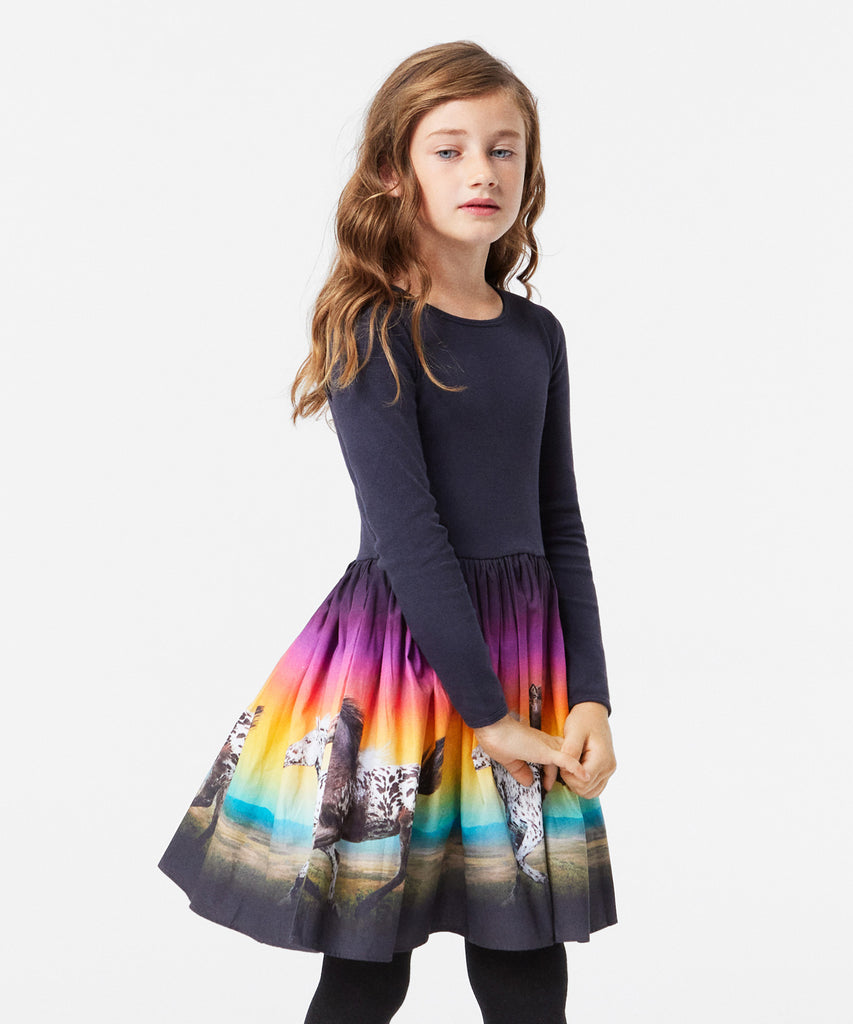 Details: Long-sleeved black dress in organic cotton with a fitted ribbed jersey top, round neck, and a voluminous full skirt in cotton poplin. The skirt is adorned with a colourful print of galloping horses.&nbsp;
This Molo product is GOTS Organic certified by Ecocert Greenlife, License no. 197496.&nbsp;
Color: Magic sunset&nbsp;&nbsp;
Composition:&nbsp;100% Organic cotton&nbsp;