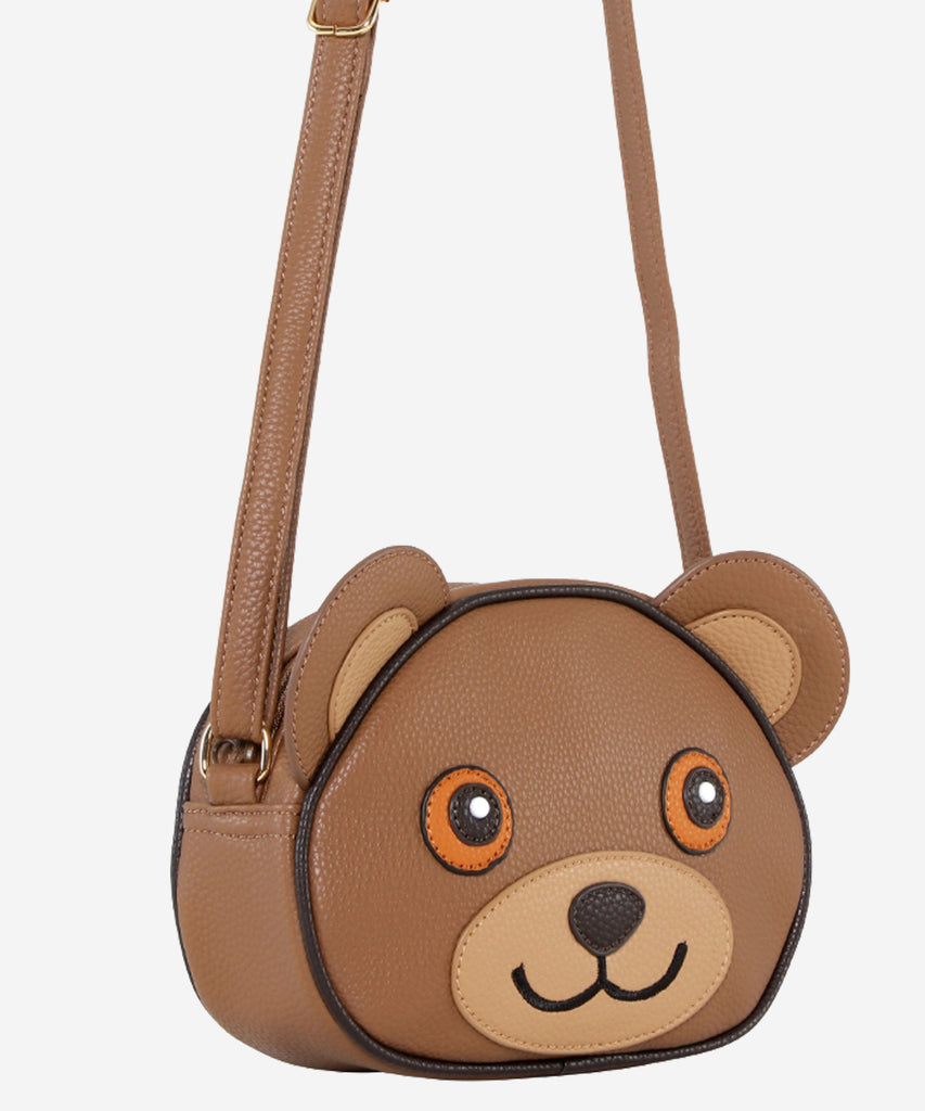 Details:&nbsp; Our Teddy Bear Cross Body bag is the perfect companion for any adventure! This bag features an adorable Teddy Bear design and zip closure to make sure your items are safe and secure. With this stylish bag, you're sure to be a hit no matter where your day takes you!&nbsp; Color: Brown&nbsp; Composition:&nbsp; 100% Polyurethane&nbsp;