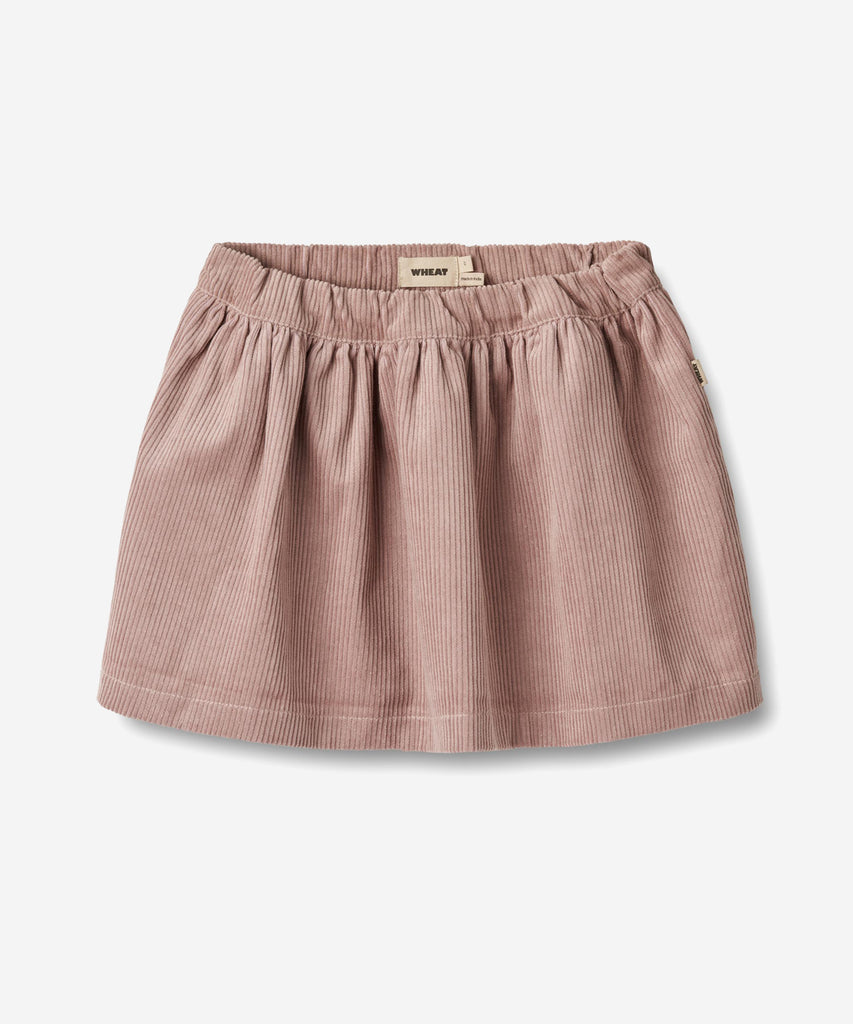 Details:
Sweet skirt in soft organic cotton for the junior child.
- Length: above knees
- Side pockets
- Adjustable elastic at the waist
- Gatherings below waistband
- Coduroy fabric
Wheat's lovely skirts can easily become a permanent part of your child’s everyday wardrobe depending on how you style them. Style them with some leggings, a T-shirt and a knit for the colder autumn and winter months. The skirt has a wide shape with an adjustable elastic at the waist and gatherings at the top for some volume. Th