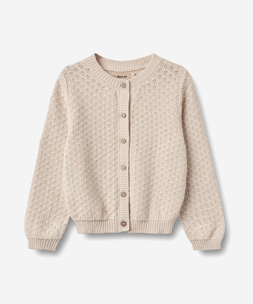 Details:&nbsp;
Long-sleeved knit cardigan in soft organic cotton for children.
- Buttons down the front
- Rib at the neckline, cuffs and bottom hem
- Structured knit pattern
Wheat's knitwear is a true essential during the everchanging seasons, as it is soft and comfortable for your child to wear without any kind of itchiness. Our knits have a classic look with a relaxed fit that make them easy to style with any outfit and works well as a warmer layer over one of our t-shirts, shirts or dresses. It is also p